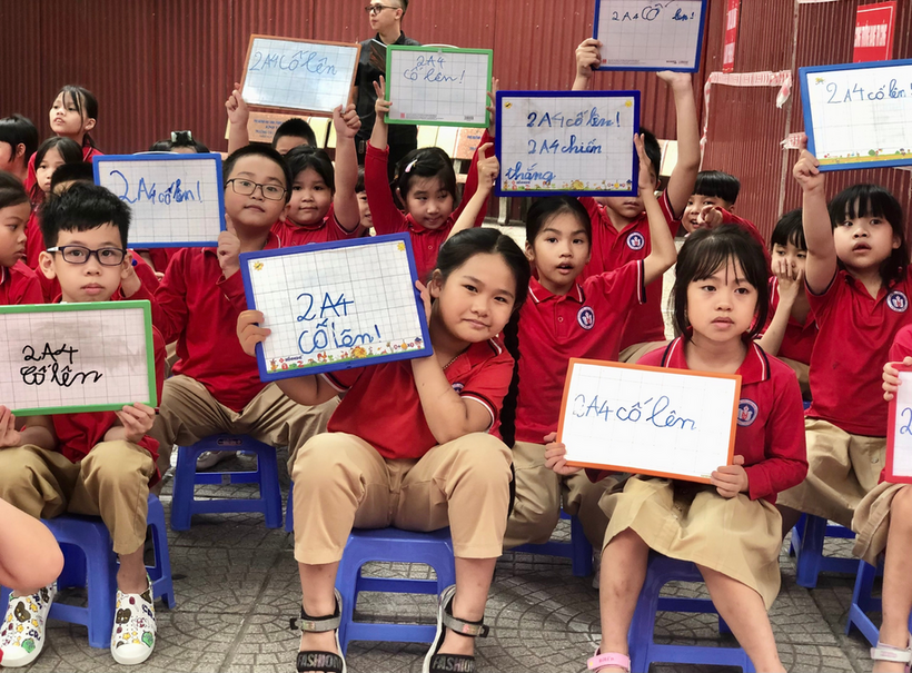 A group of children holding signs
Description automatically generated with medium confidence