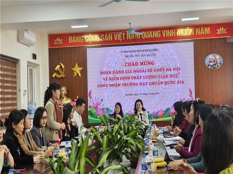 A group of people sitting at a table
Description automatically generated