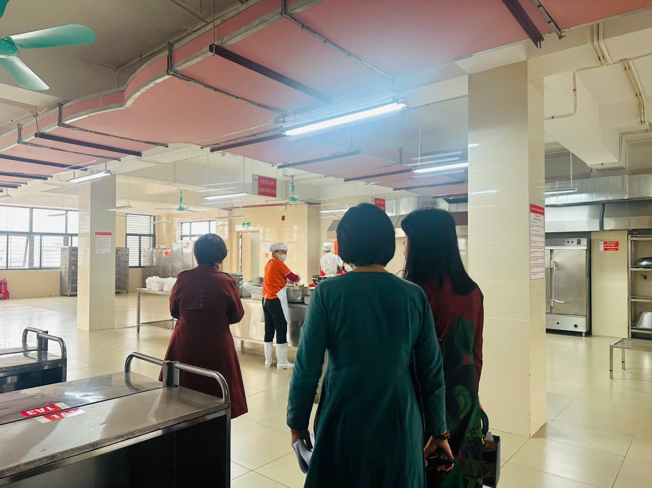 A group of people in a kitchen
Description automatically generated