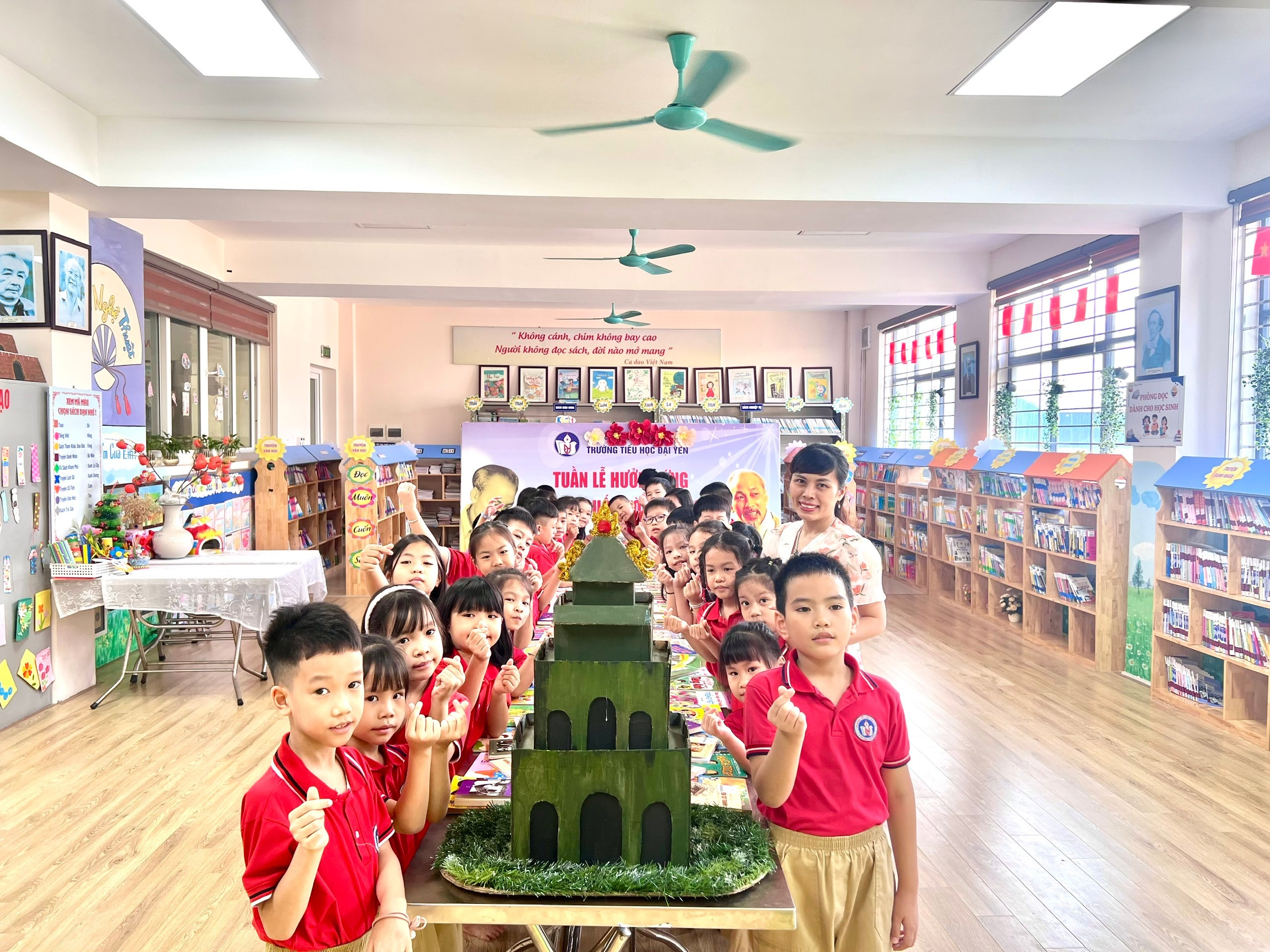 A group of children in a room with a table with a green building
AI-generated content may be incorrect.