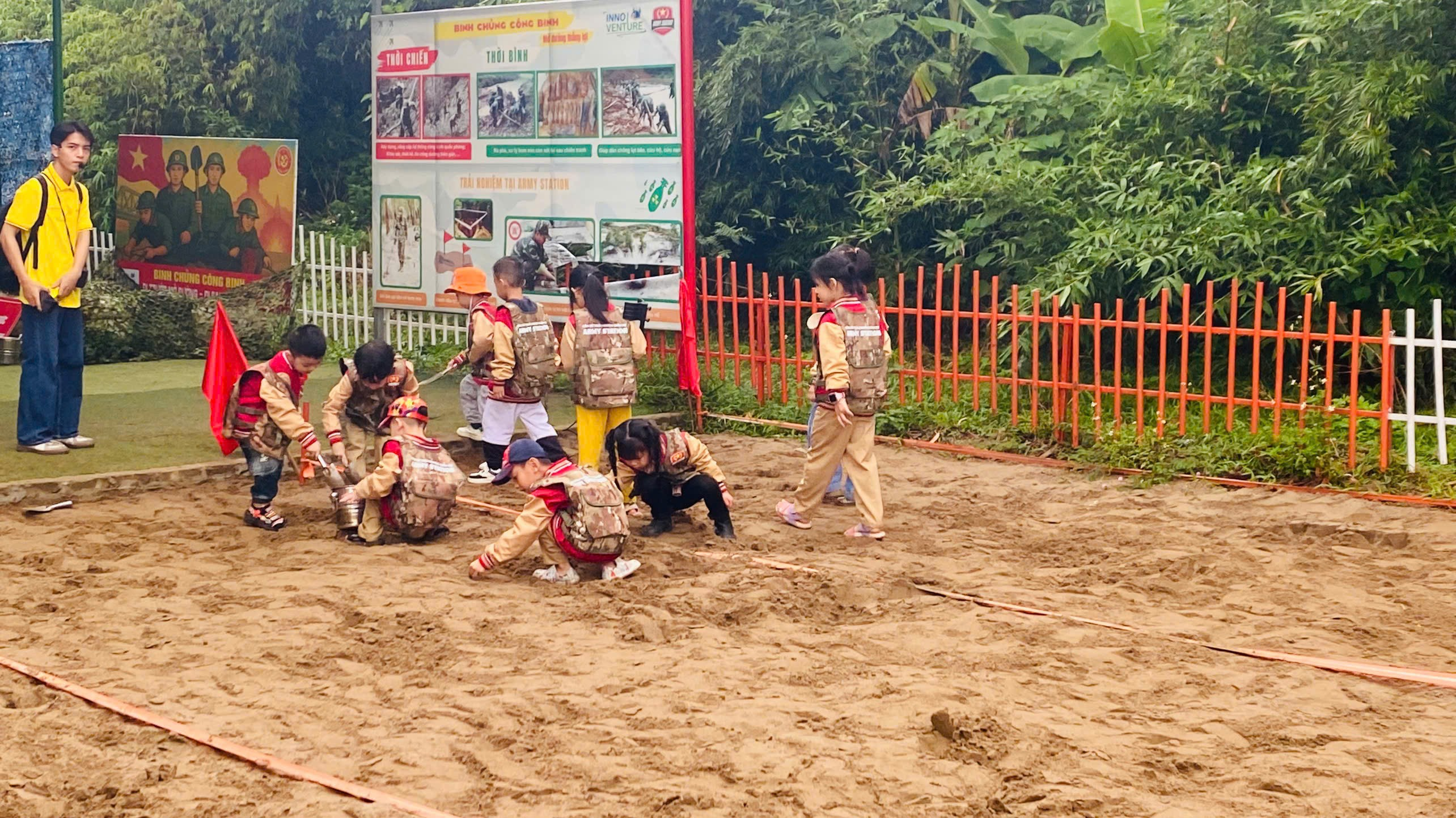 A group of children in uniform playing in the dirt

AI-generated content may be incorrect.