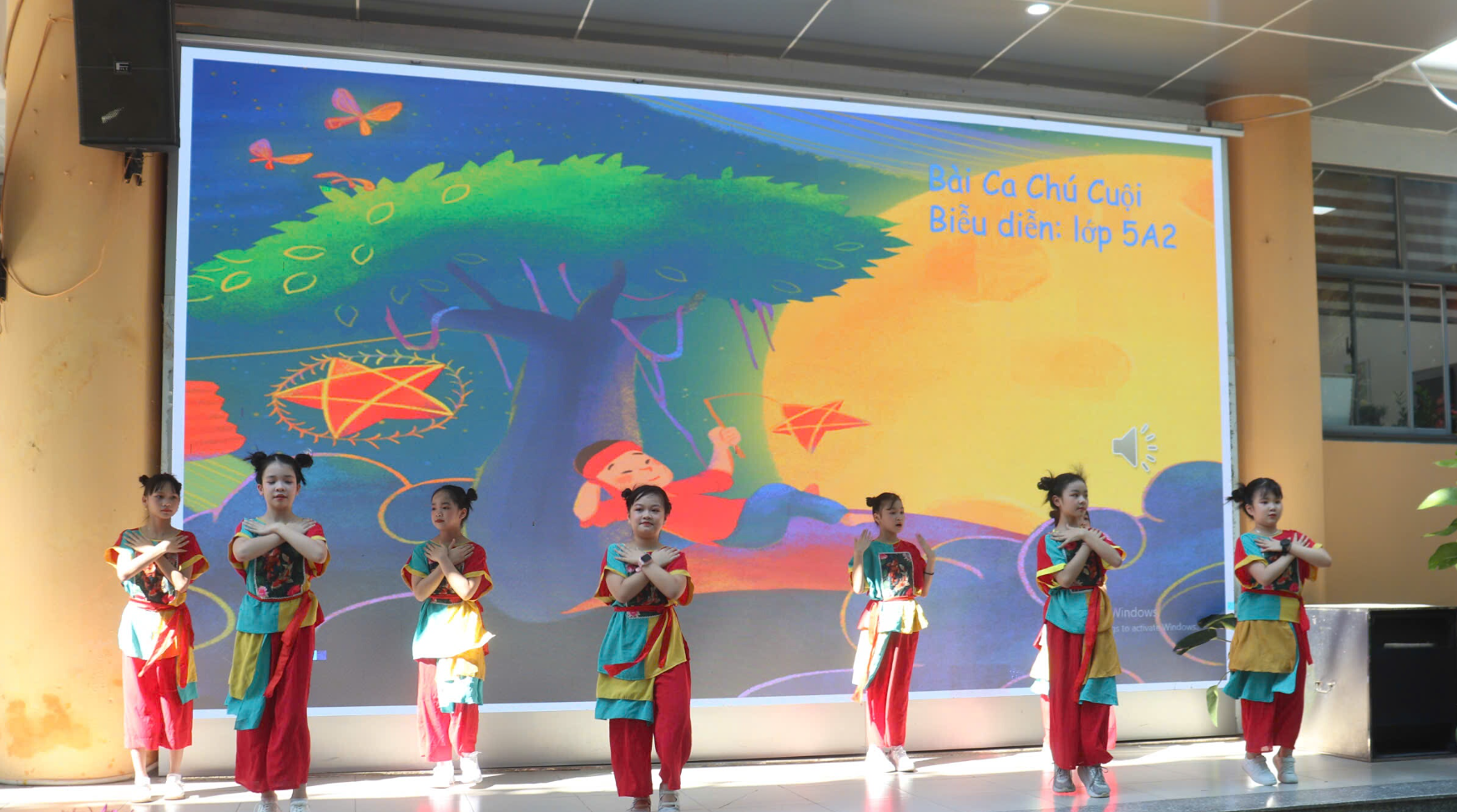 A group of children performing on stage
AI-generated content may be incorrect.