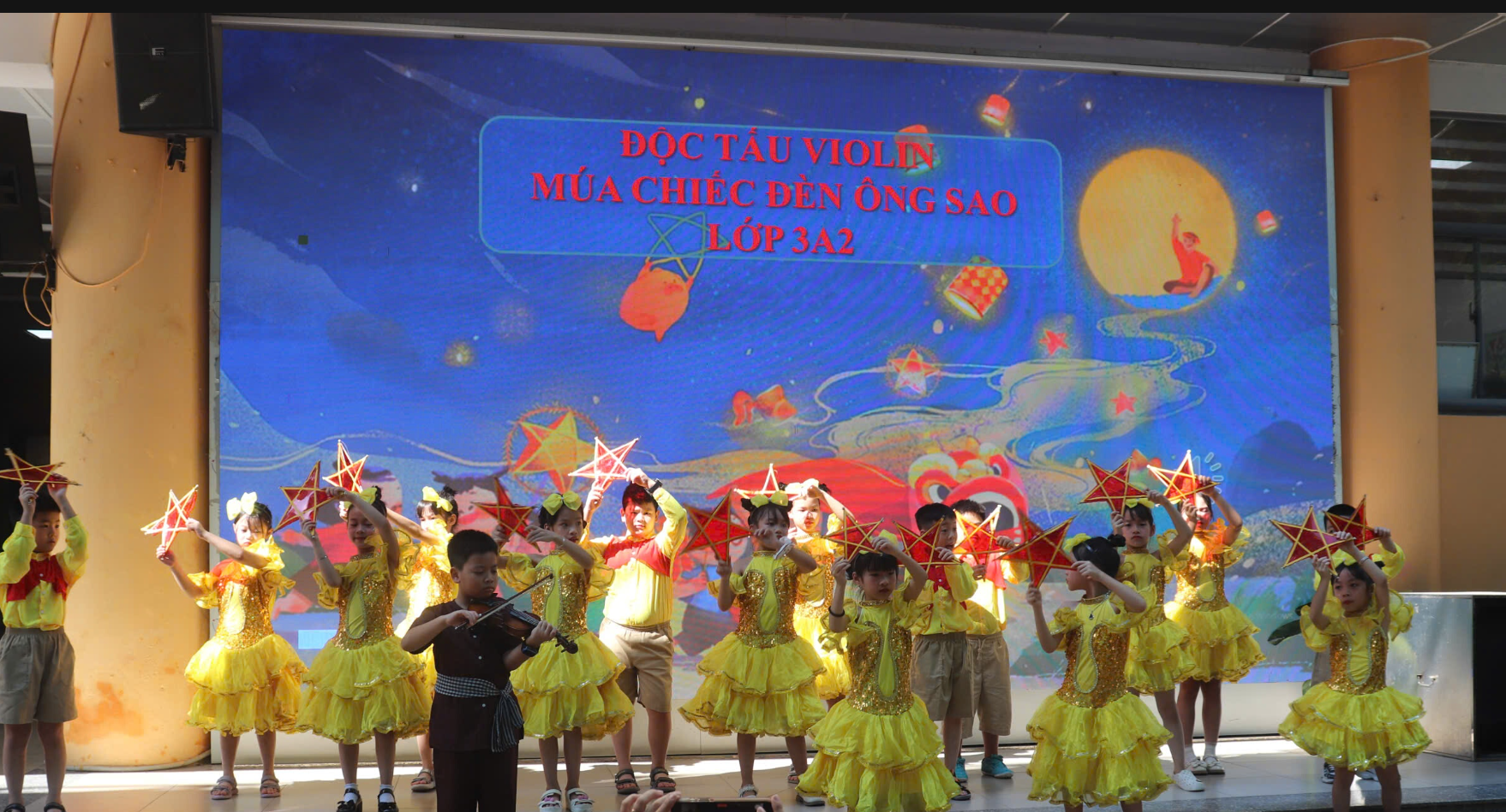 A group of children in yellow dresses dancing on stage
AI-generated content may be incorrect.