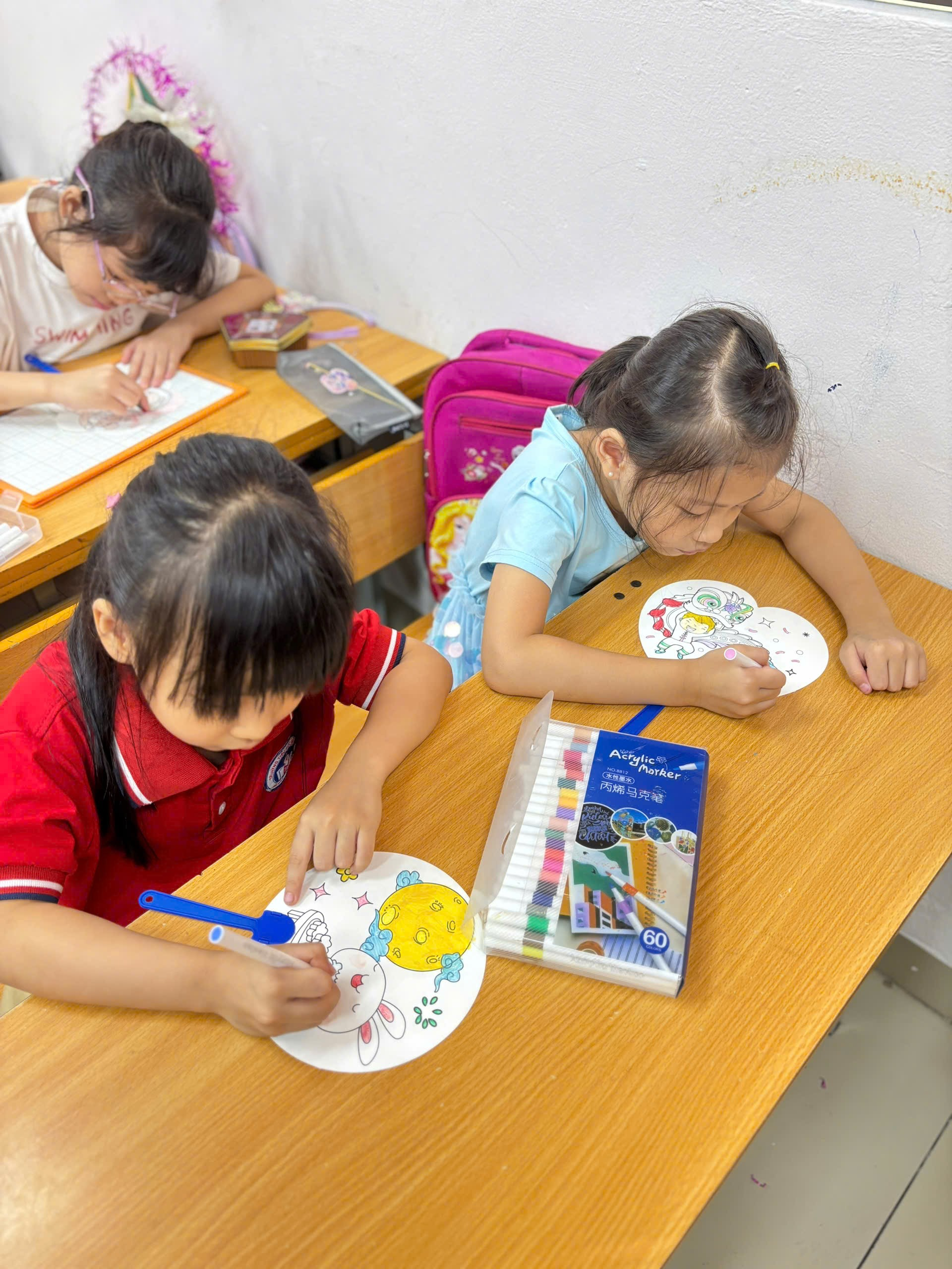 A group of children painting on paper
AI-generated content may be incorrect.