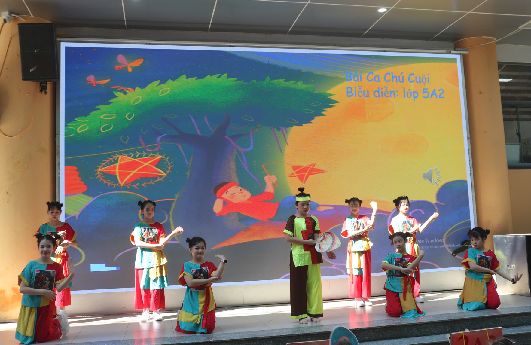 A group of children performing on stage
AI-generated content may be incorrect.