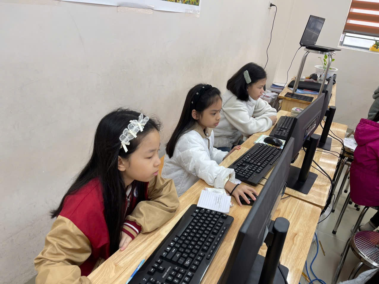 A group of girls sitting at computers

AI-generated content may be incorrect.