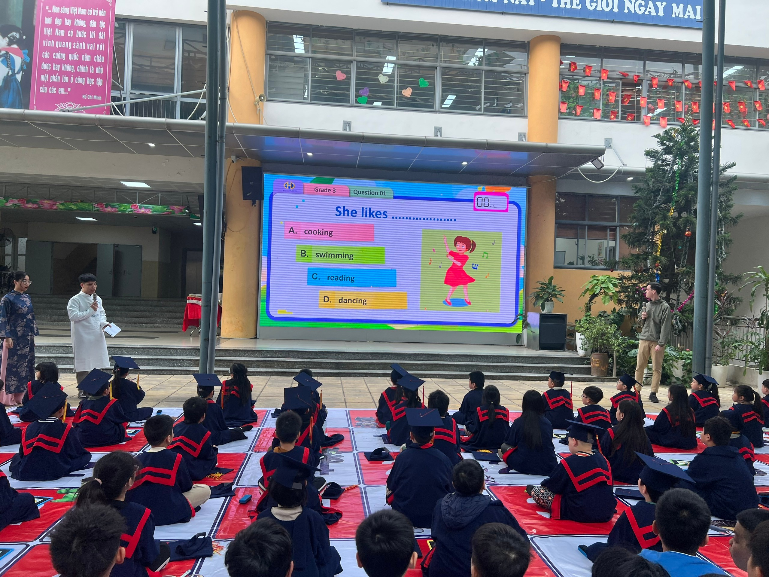 A group of children sitting on the ground in front of a large screen

AI-generated content may be incorrect.