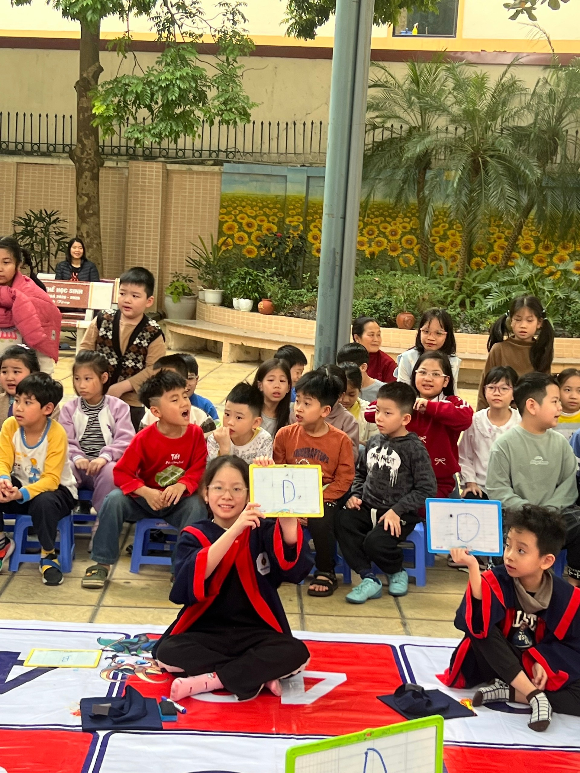 A group of children sitting on the ground

AI-generated content may be incorrect.