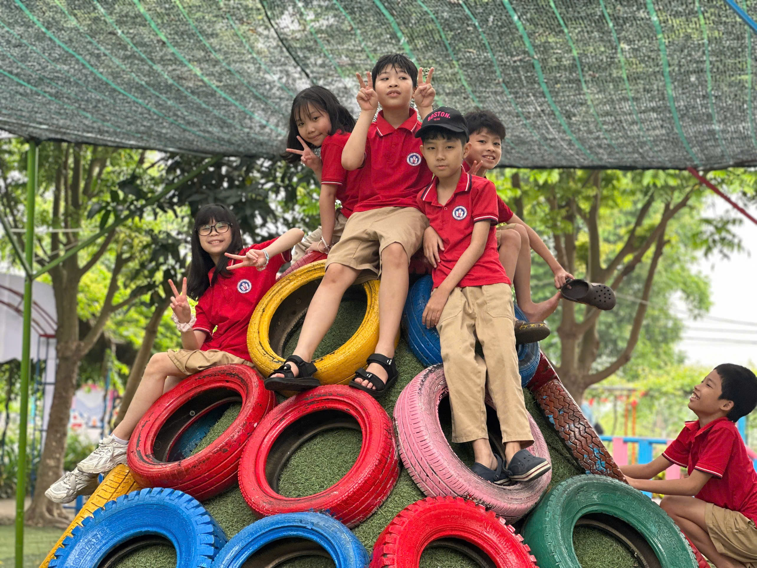A group of kids sitting on a pile of tires

AI-generated content may be incorrect.